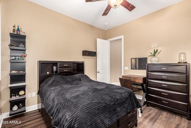 bedroom featuring baseboards, ceiling fan, and wood finished floors