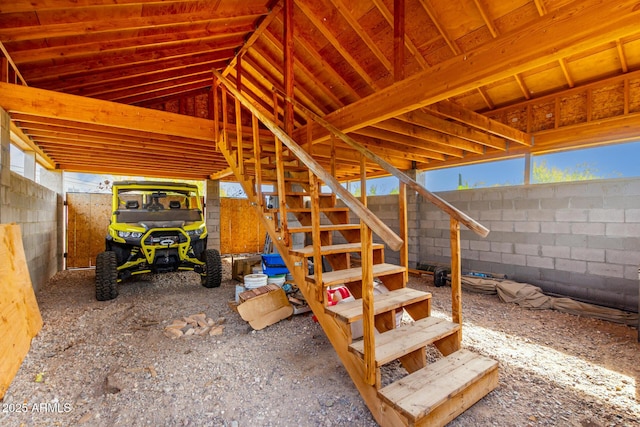 view of patio / terrace featuring fence and stairs