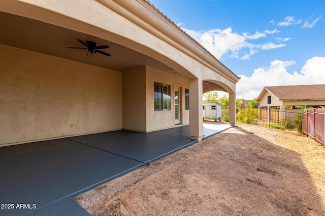 view of patio with a ceiling fan and fence