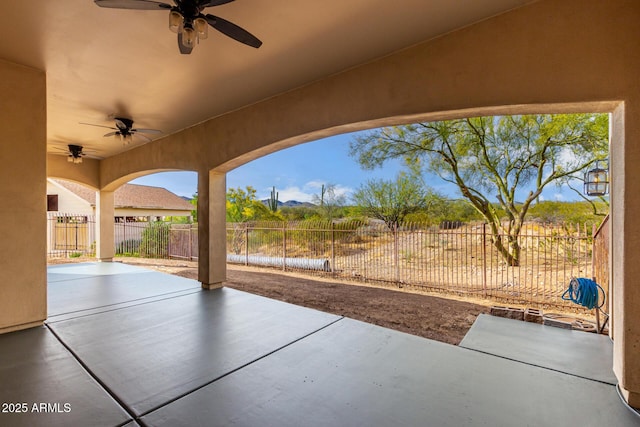 view of patio / terrace with ceiling fan and fence