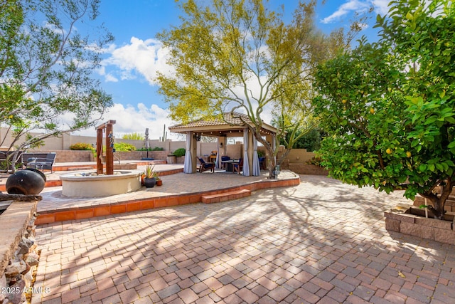 view of patio / terrace with a gazebo and a fenced backyard