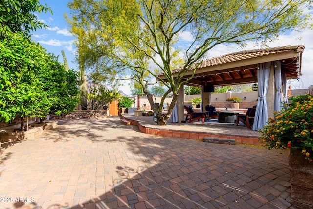 view of patio featuring a gazebo and fence