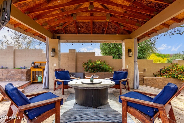 view of patio featuring a fenced backyard, an outdoor hangout area, and a gazebo