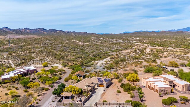 birds eye view of property featuring view of desert and a mountain view