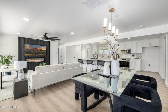 215 W Ruth Ave, Phoenix, AZ 85021 - dining room with light wood-style flooring, ceiling fan, and recessed lighting