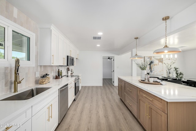 215 W Ruth Ave, Phoenix, AZ 85021 - kitchen with stainless steel appliances, decorative backsplash, light wood-style flooring, white cabinets, and recessed lighting