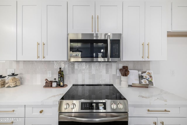 215 W Ruth Ave, Phoenix, AZ 85021 - kitchen featuring stainless steel appliances, white cabinetry, and backsplash