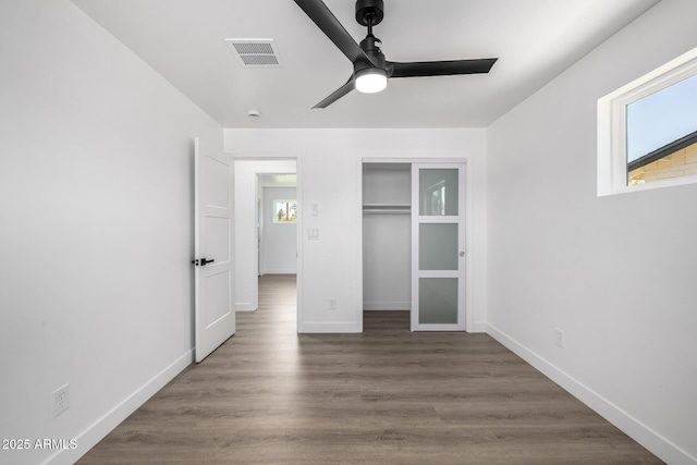 215 W Ruth Ave, Phoenix, AZ 85021 - unfurnished bedroom with wood finished floors, a closet, and a ceiling fan