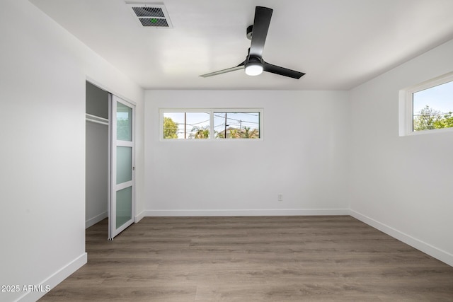 215 W Ruth Ave, Phoenix, AZ 85021 - unfurnished bedroom with wood finished floors, a ceiling fan, and a closet