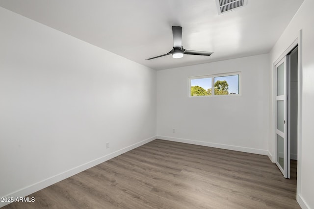 215 W Ruth Ave, Phoenix, AZ 85021 - unfurnished bedroom featuring wood finished floors, ceiling fan, and a closet