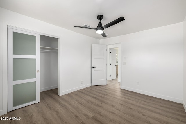 215 W Ruth Ave, Phoenix, AZ 85021 - unfurnished bedroom with wood finished floors, a closet, and a ceiling fan
