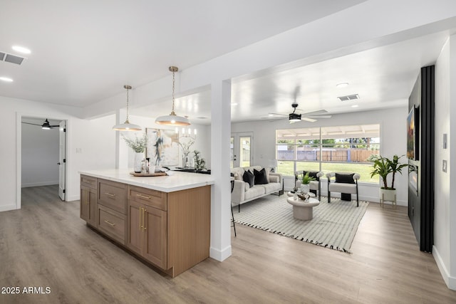 215 W Ruth Ave, Phoenix, AZ 85021 - kitchen with a ceiling fan, light wood finished floors, light countertops, and recessed lighting