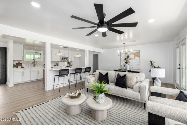 215 W Ruth Ave, Phoenix, AZ 85021 - living room featuring light wood-type flooring, recessed lighting, a chandelier, and a ceiling fan