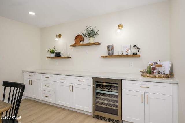 bar featuring light wood finished floors, wine cooler, and recessed lighting