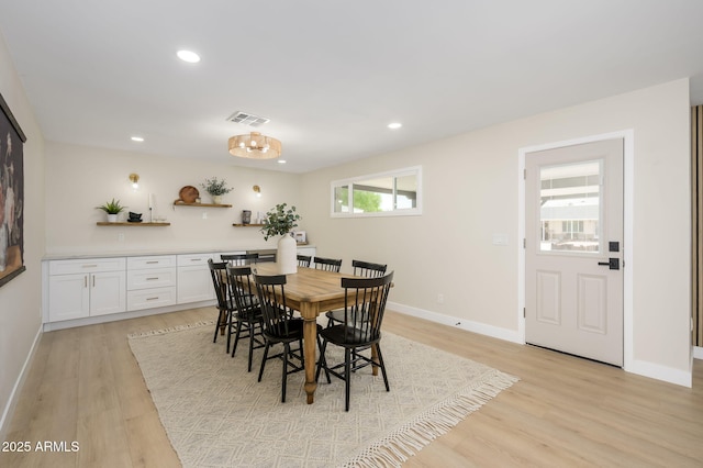 dining space featuring baseboards, visible vents, light wood-style flooring, and recessed lighting