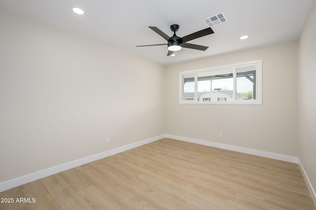 spare room with recessed lighting, baseboards, light wood finished floors, and visible vents