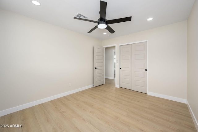 unfurnished bedroom featuring light wood-type flooring, recessed lighting, baseboards, visible vents, and a closet