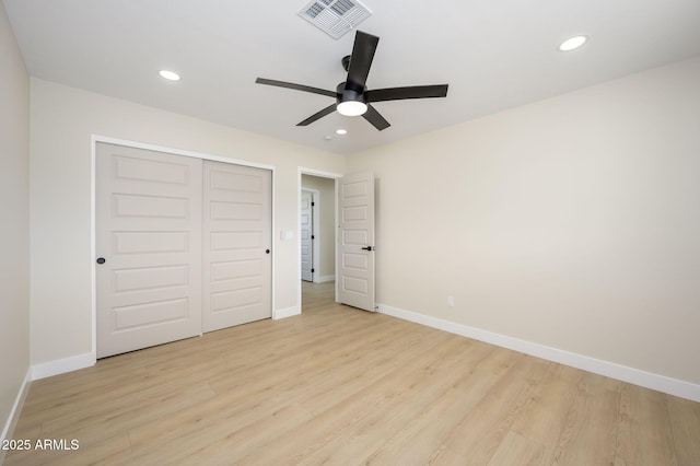 unfurnished bedroom with baseboards, light wood-style flooring, and visible vents