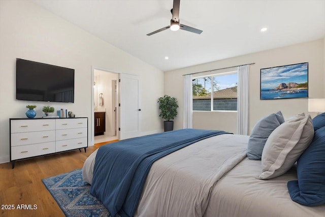 bedroom with hardwood / wood-style flooring, ensuite bath, lofted ceiling, and ceiling fan