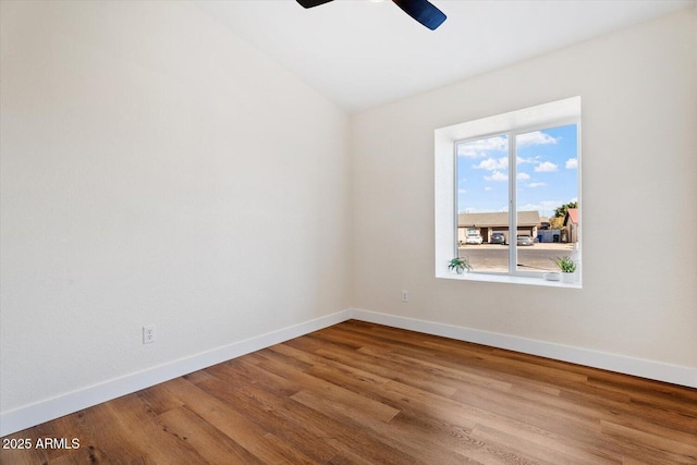 spare room with hardwood / wood-style floors and ceiling fan