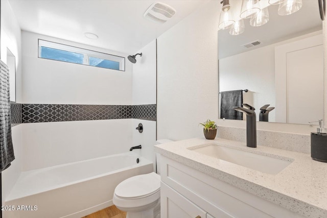 full bathroom featuring bathing tub / shower combination, vanity, and toilet