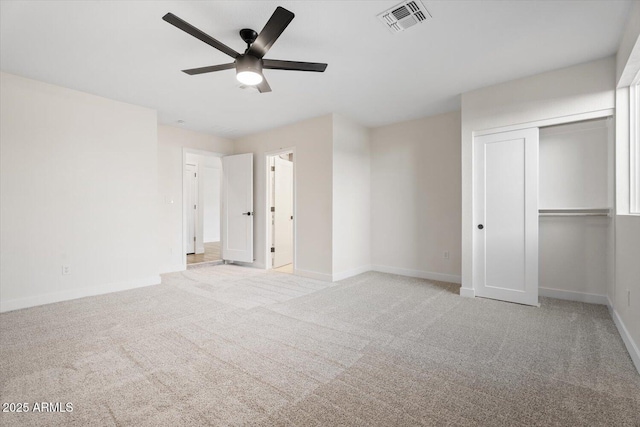 unfurnished bedroom with light carpet, a closet, and ceiling fan