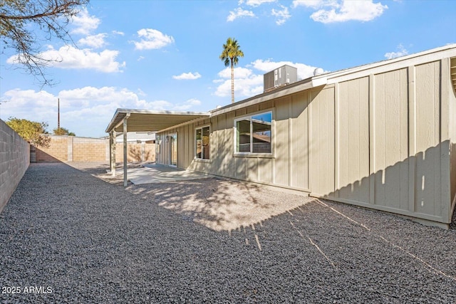 rear view of house with central AC and a patio