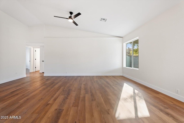 empty room featuring ceiling fan, vaulted ceiling, and wood-type flooring