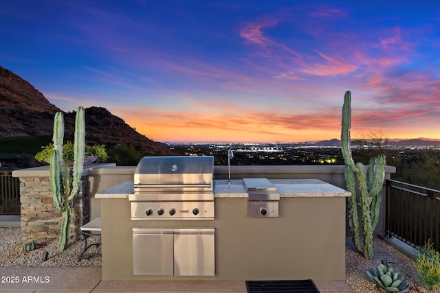 view of patio with a mountain view and area for grilling