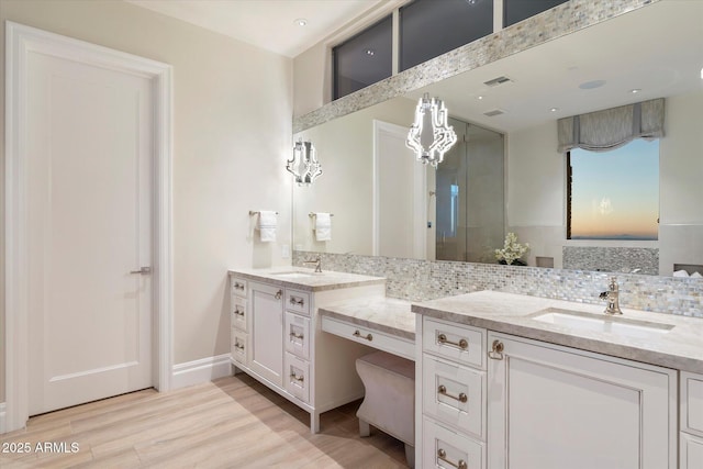 full bath with visible vents, wood finished floors, backsplash, and vanity