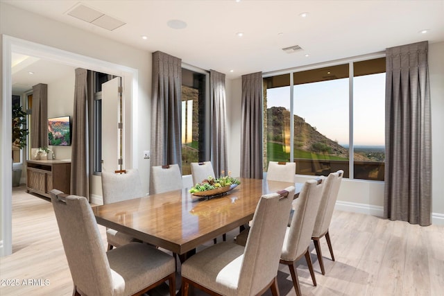 dining area with baseboards, light wood-type flooring, visible vents, and recessed lighting