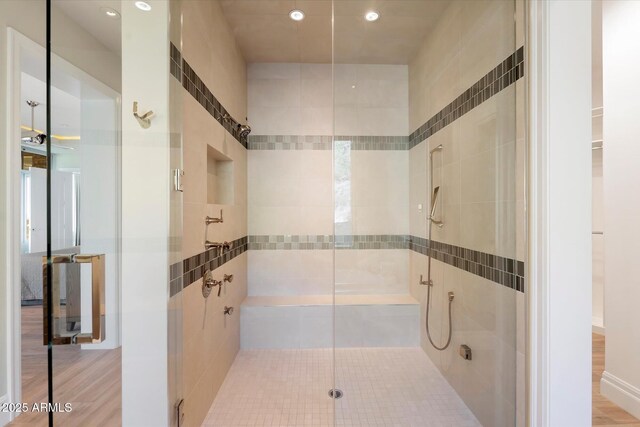 full bathroom featuring a shower stall and wood finished floors