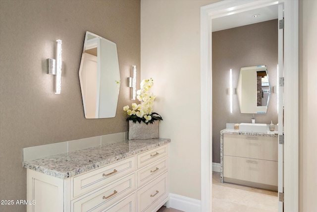 bathroom with baseboards and vanity