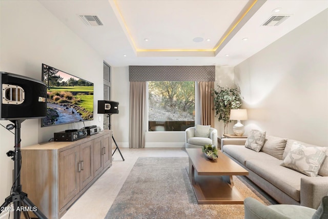 living room featuring recessed lighting, a raised ceiling, visible vents, and baseboards