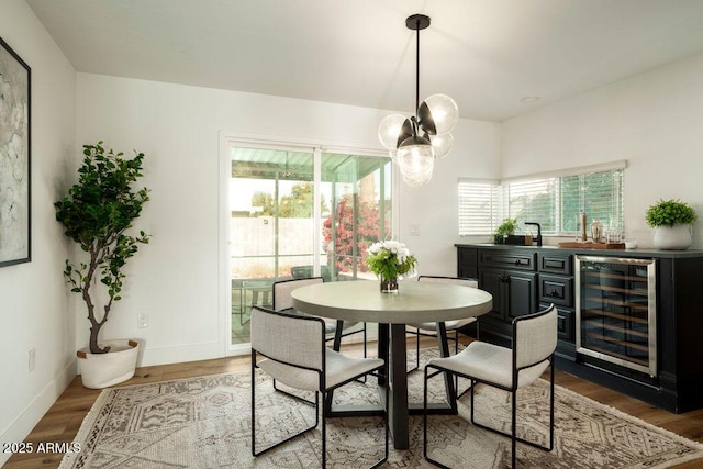 dining room with hardwood / wood-style flooring and beverage cooler