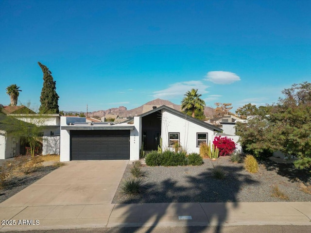 view of front of house with a mountain view and a garage