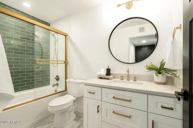 full bathroom with vanity, bath / shower combo with glass door, and toilet