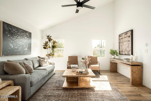 living room featuring hardwood / wood-style floors, ceiling fan, a healthy amount of sunlight, and high vaulted ceiling