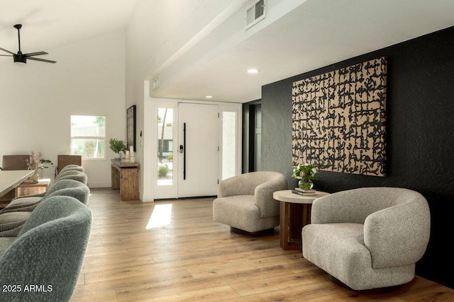 living room with ceiling fan, light wood-type flooring, and elevator