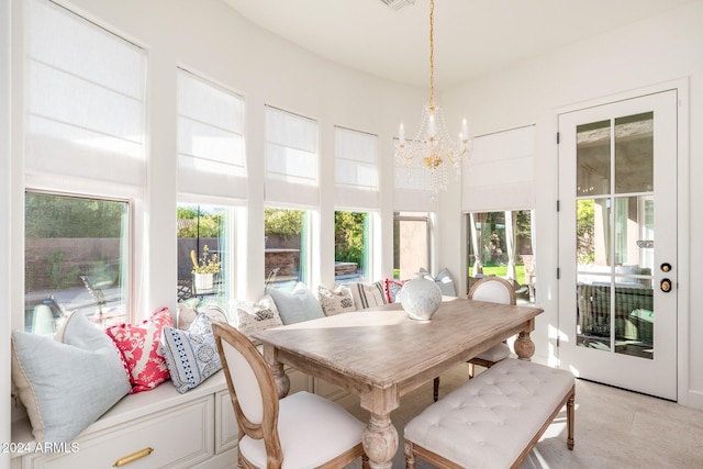 sunroom / solarium with a notable chandelier