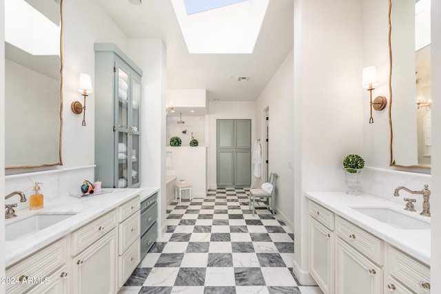 bathroom with vanity and a skylight