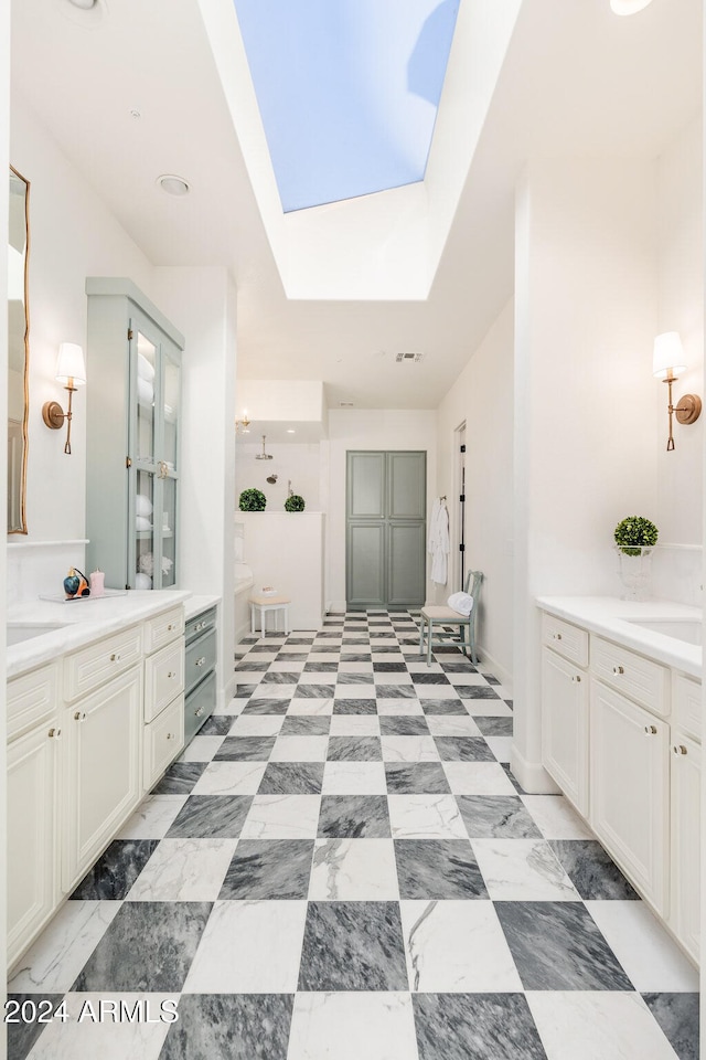 bathroom featuring a skylight and vanity