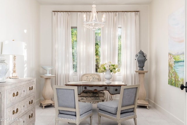 living area with plenty of natural light, light tile patterned flooring, and a chandelier