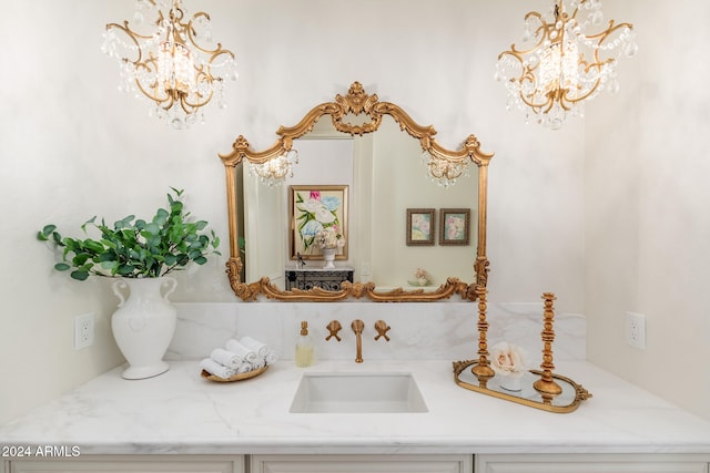 details with vanity and an inviting chandelier