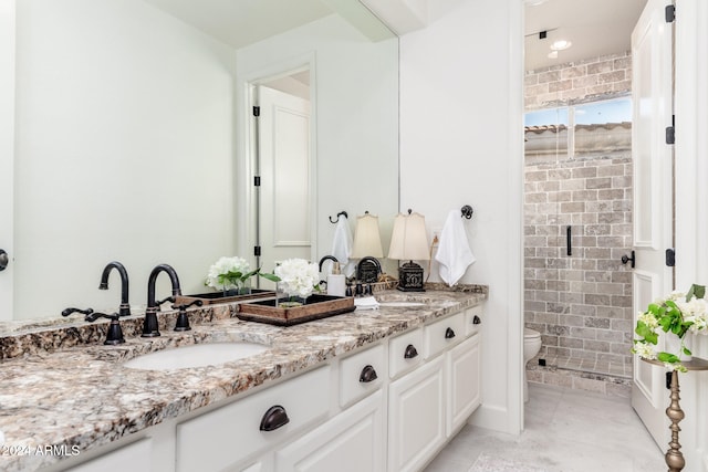 bathroom with vanity, toilet, and tile walls