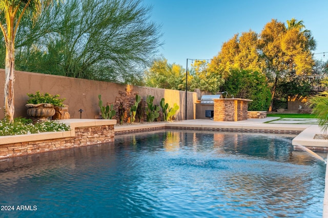 view of swimming pool featuring area for grilling