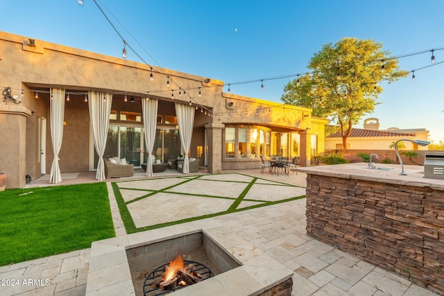 back of property featuring outdoor lounge area, ceiling fan, and a patio area