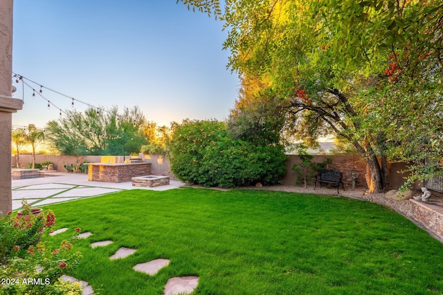 yard at dusk featuring a patio area