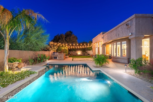 pool at night with a patio