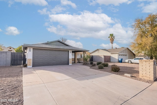 ranch-style house with a garage, a gate, fence, and driveway